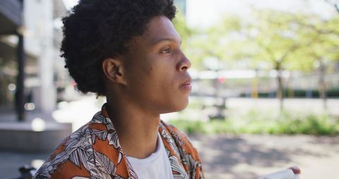 Young Man Enjoying Coffee Break in Urban Park