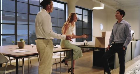 Diverse Colleagues Engaged in Friendly Office Discussion