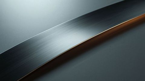 Precision curved steel blade with gold edge highlight