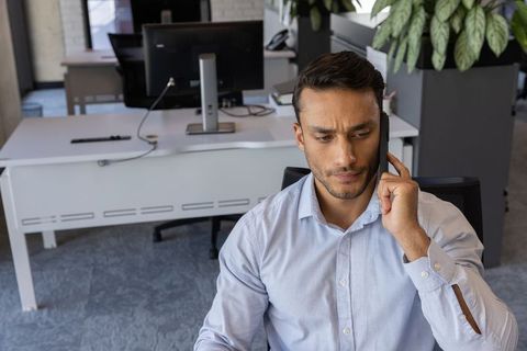 Focused Office Worker Engaging in Business Call at Desk
