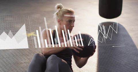 Female athlete performing seated core workout with medicine ball and analytics overlay