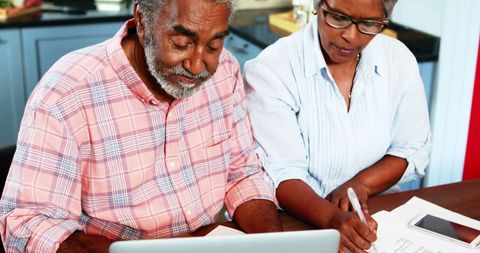 Senior Couple Managing Finances at Home with Laptop and Bills - Download Free Stock Images Pikwizard.com