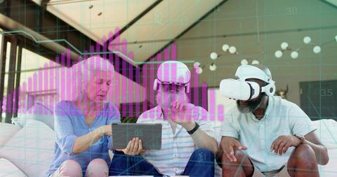Mature adults collaborating with VR headsets and tablet, magenta data visualization overlay