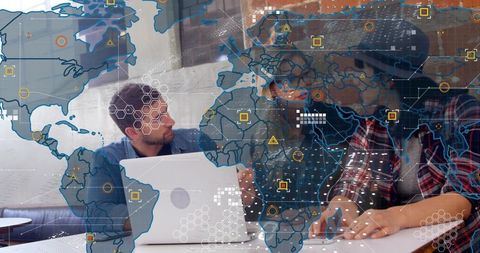 Global team collaborating and visualizing data with world map overlay on laptop for analytics