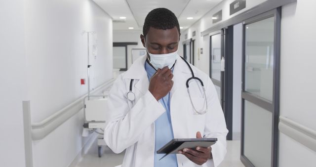 African American Doctor Using Tablet in Hospital Corridor - Download Free Stock Images Pikwizard.com