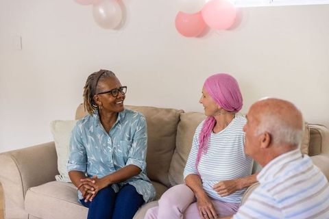 Diverse senior friends engaged in home celebration and conversation