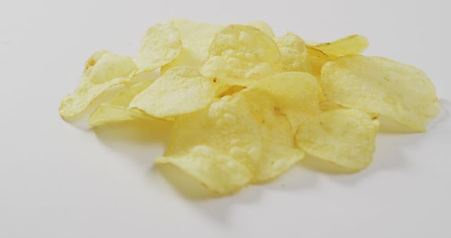 Close up of potato chips with copy space on white surface. food and snack concept