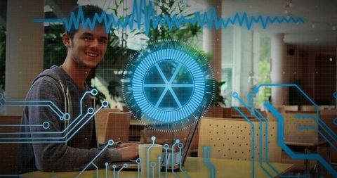 Young Professional Using Laptop with Futuristic Technology Overlay