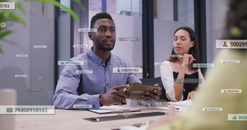 Business team presenting data with floating analytics overlays in modern conference room