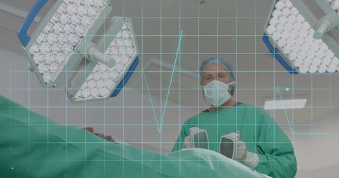 surgeon holding defibrillator in operating room with data overlay - Download Free Stock Images Pikwizard.com