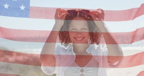 Smiling Woman Enjoying Patriotic Beach Day with USA Flag - Download Free Stock Images Pikwizard.com