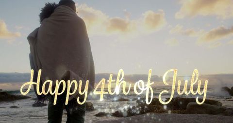 Couple Embracing Seaside Sunset Celebrating Fourth of July