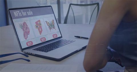 Woman browsing nft marketplace on laptop in modern meeting room for digital art collectibles