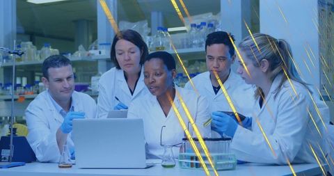 Diverse Scientists Analyzing Data in Laboratory with Laptops and Test Tubes
