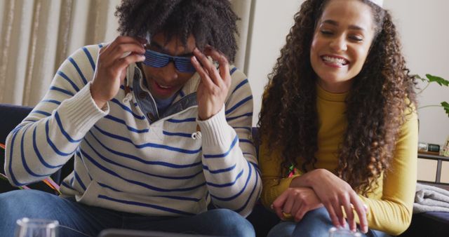 Young Duo Laughing, Playing with Glasses in Cozy Living Room - Download Free Stock Images Pikwizard.com