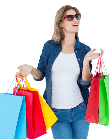 Smiling woman wearing sunglasses holding shopping bags