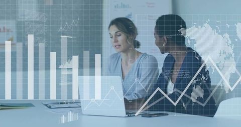 Two Businesswomen Analyzing Data on Laptop, Modern Conference Atmosphere