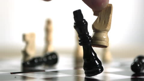 Hand Capturing Chess King with Knight in Dramatic Scene