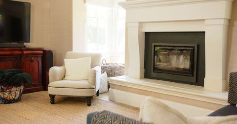 Elegant Living Room Interior with Armchair by Fireplace - Download Free Stock Images Pikwizard.com