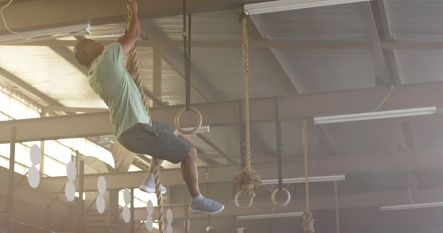 Man Climbing Rope in Gym for Strength Training - Download Free Stock Images Pikwizard.com