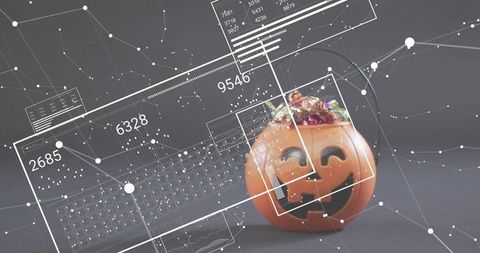 Futuristic halloween pumpkin bucket with candy and digital data overlay for tech concept
