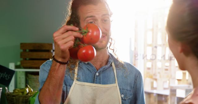 Smiling Market Vendor Holding Fresh Tomatoes - Download Free Stock Images Pikwizard.com