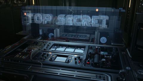 Projecting holographic top secret over rugged electronic console in secure lab