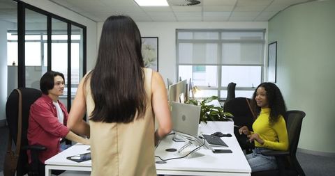 Diverse Team Collaborating in Modern Open-Plan Office Environment