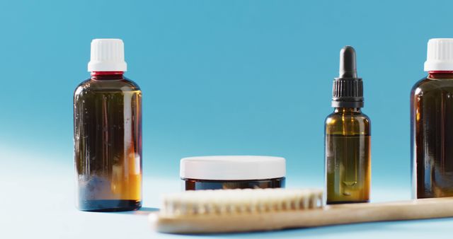 Natural Skincare Bottles and Tools on a Blue Background - Download Free Stock Images Pikwizard.com