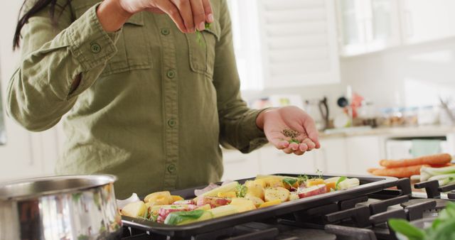 Person Seasoning Vegetables for Cooking in Modern Kitchen - Download Free Stock Images Pikwizard.com