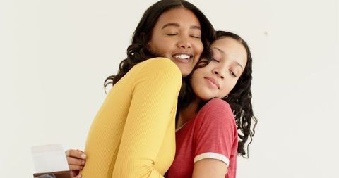 Loving Embrace Between African American Mother and Daughter