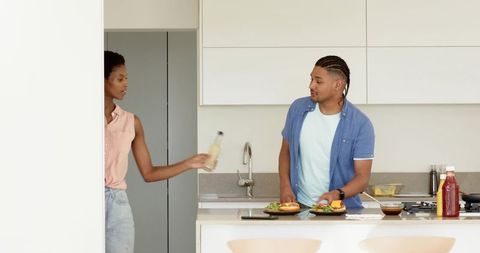 Diverse Couple Cooking Open-Faced Sandwiches in Modern Kitchen