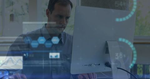 business professional analyzing data on desktop with futuristic display - Download Free Stock Images Pikwizard.com