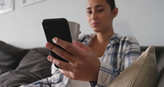 Young Woman Relaxing on Sofa Using Smartphone and Drinking Coffee - Download Free Stock Images Pikwizard.com