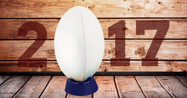 Digital composite image of rugby ball forming 2017 against wooden background