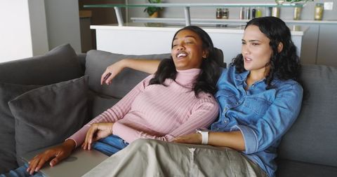 Diverse Female Friends Relaxing and Laughing at Home Together