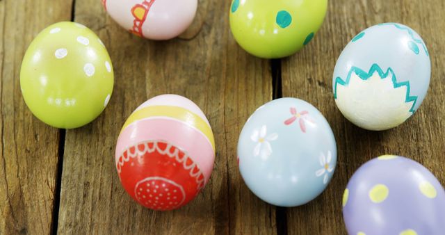 Colorful painted Easter eggs are arranged on a wooden surface, with copy space - Download Free Stock Photos Pikwizard.com