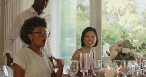 Diverse Guests at Elegant Wedding Reception with Floral Centerpiece