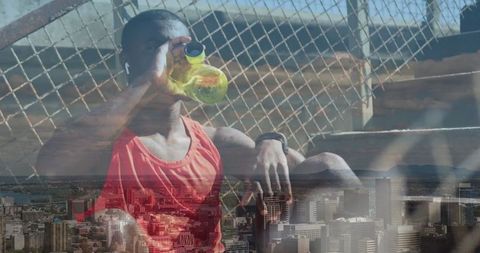 Athlete Hydrating Overlaid with Urban Cityscape