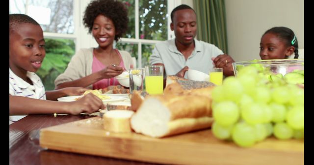 Happy Family Eating Breakfast at Home Table With Bread and Fruits - Download Free Stock Images Pikwizard.com