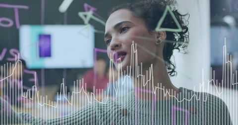 Businesswoman Sketching Data Visualization on Glass Board During Team Brainstorming Session