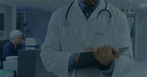 Doctor Note Taking in Hospital Corridor with Stethoscope