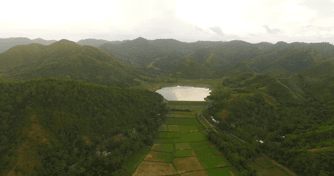 transparent lake among verdant mountains and fields at sunrise - Download Free Stock Videos Pikwizard.com