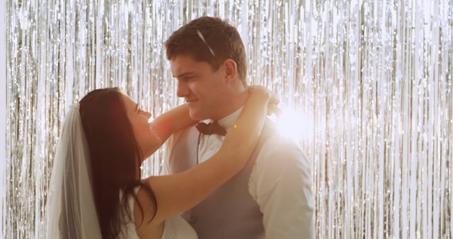 Newlywed Couple Embracing at Wedding Reception with Glittering Background - Download Free Stock Images Pikwizard.com