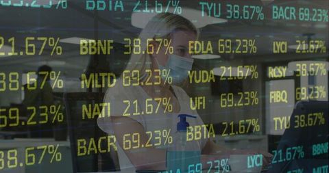 Businesswoman Analyzing Stock Market Tickers in Modern Office