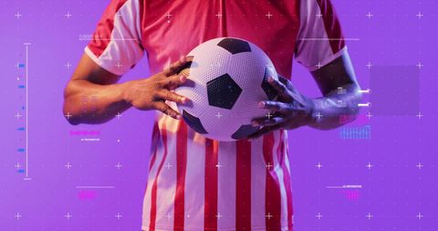 Soccer Player Holding Ball on Vibrant Purple Background - Download Free Stock Images Pikwizard.com