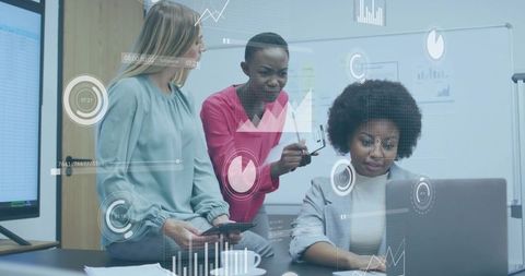 Multicultural team collaborating on laptop, analyzing augmented data overlays in boardroom