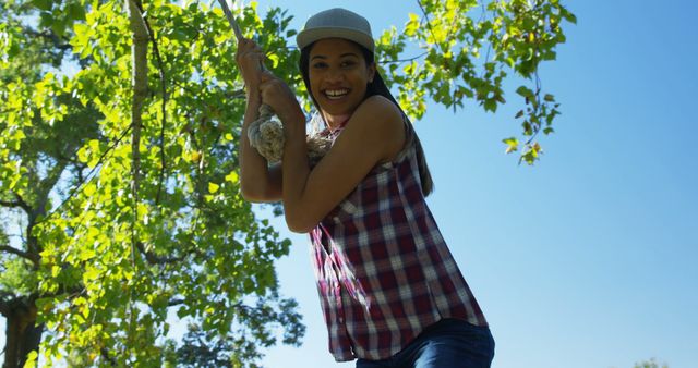 Woman Swinging on Tree Rope Outdoors in Sunny Weather - Download Free Stock Images Pikwizard.com