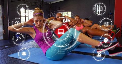 Women performing core twists on blue mats with wearable tracking hud for group fitness