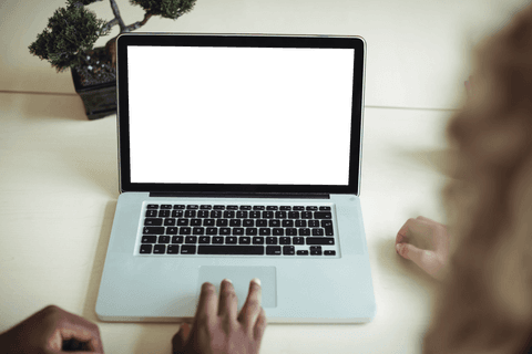Business professionals collaborating at transparent laptop display